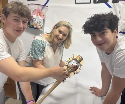 Dr. Nell Daniel guiding a young artist in the studio