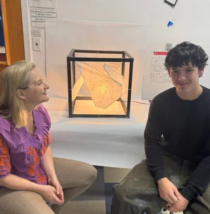 Dr. Nell Daniel with a student and their finished portfolio work